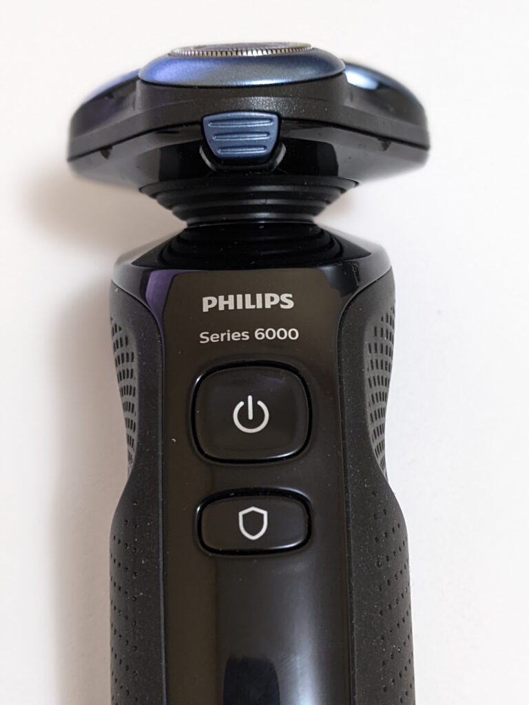 Close up of the front of the Philips S6680 which shows both the power button as well as the Guard Mode button