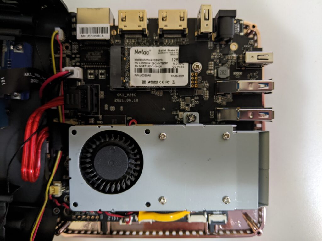 Inside the OUVISLITE mini pc.  Here we see the blower style fan that helps expel heat as well as the Netac M.2 SATA SSD among other internal components