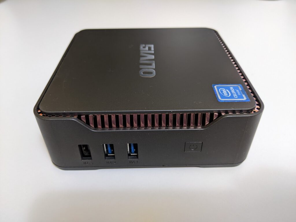 Side of the OUVISLITE mini pc which shows 1x USB 2.0 and 2x USB 3.0 as well as the power button to turn on and off the pc