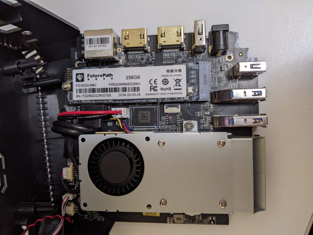 Image of the interior of the mini PC.  Featured in the picture is the blower style fan along with the NVME SSD which is a 2280 size.